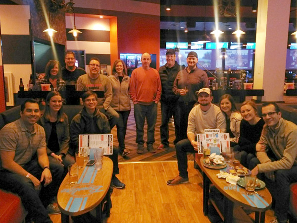 Employees at bowling alley Employees at a bowling alley facing the camera and smiling.