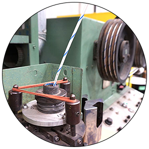 Wire Striping & Dyeing Striping machine adding dark stripes to white cable.